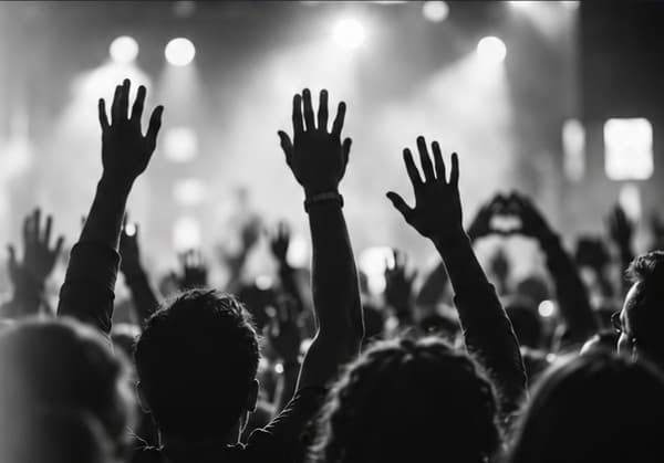 Audience members raising their hands